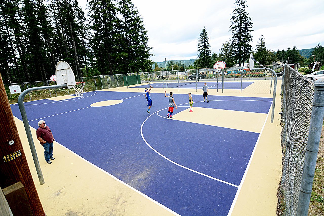 Kids play basketball at the newly resurfaced and painted courts at the Quilcene Community Center last week. (Jesse Major/Peninsula Daily News)