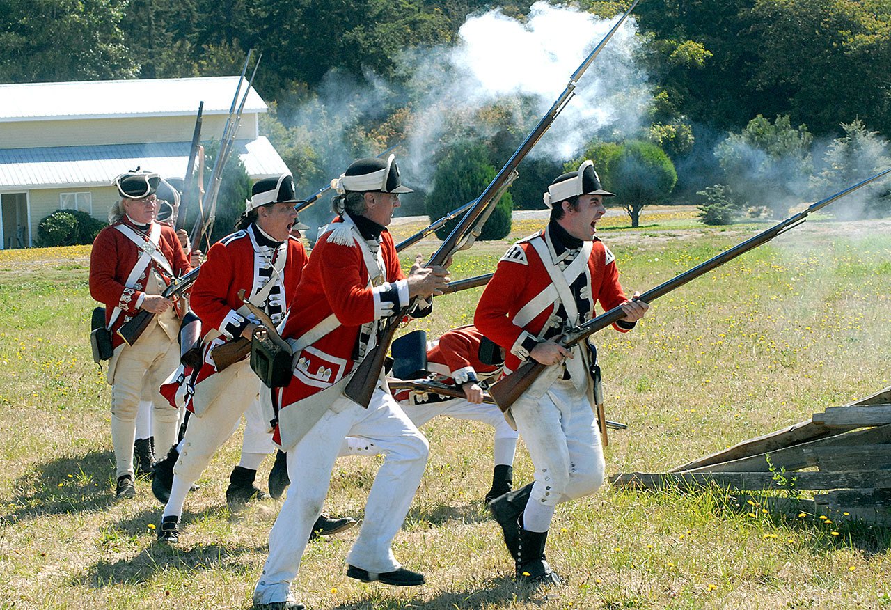 Revolutionary War reenactors stage a version of the 1775 Battle of Lexington Green on Saturday as part of the Northwest Colonial Festival at the George Washington Inn and Lavender Farm near Agnew. The festival, which continues today, features a collection of almost 60 reenactors taking part in a pair of battles, the ride of Paul Revere and a colonial encampment, as well as educational presentations and demonstrations, all sponsored by the non-profit George Washington Society. (Keith Thorpe/Peninsula Daily News)