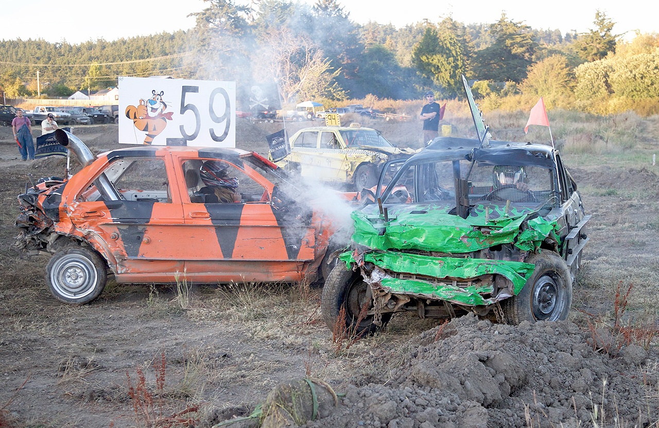 Steve Mullensky/for Peninsula Daily News Auburn’s Kylee Timlick, driving the No. 59 car, delivers the final blow to a car driven by Port Orchard’s Zach Bretcher in the kids demolition derby during the Jefferson County Fair on Saturday in Port Townsend. Timlick took home the $1,000 first prize Bretcher picked up $500 for his efforts.