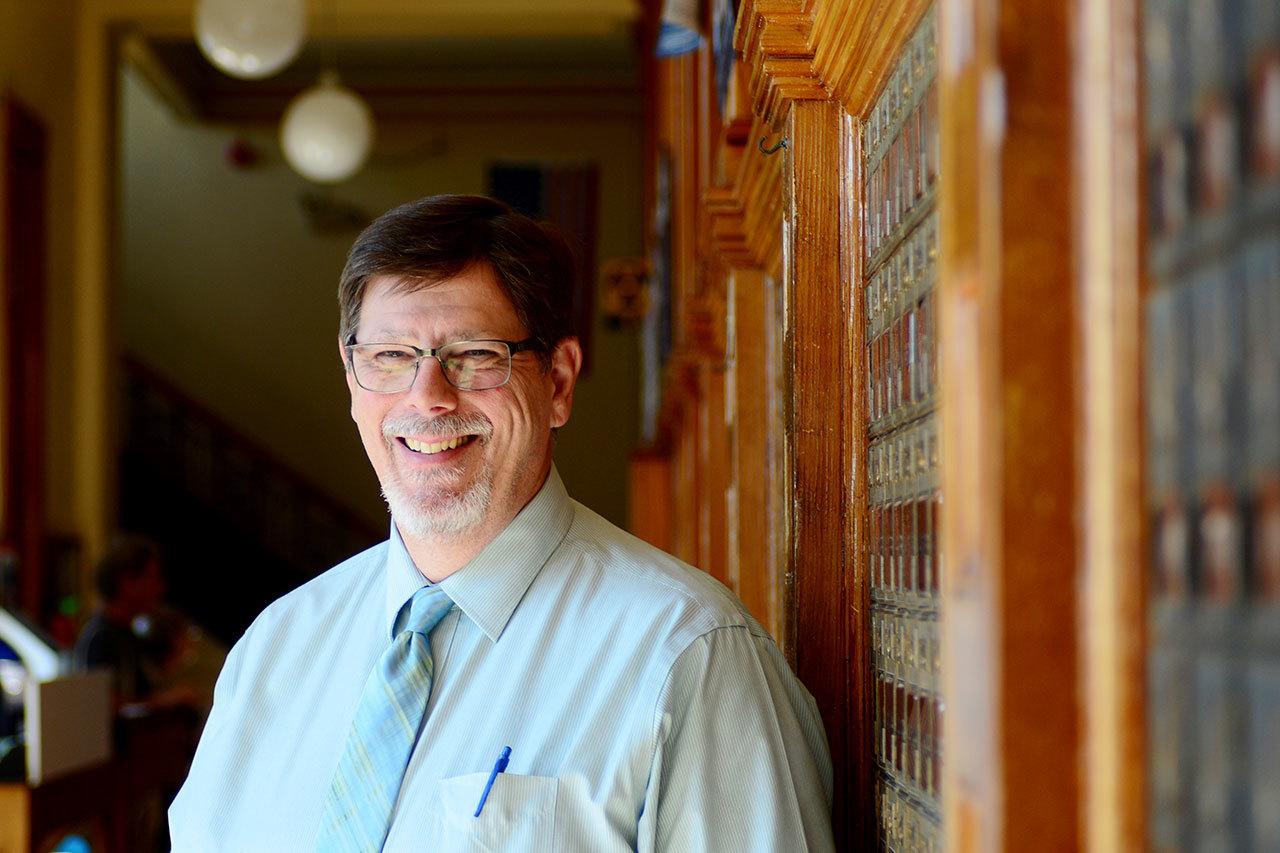 Larry Dekker started work Monday as Port Townsend’s newest postmaster. Dekker applied for the position because of his love of the sea, which he can now see through his office window. (Jesse Major/Peninsula Daily News)