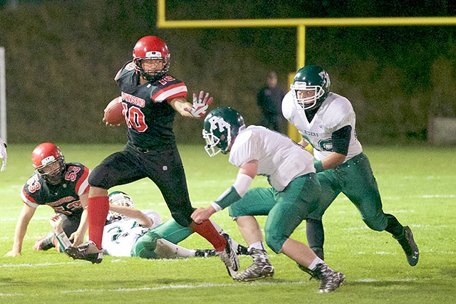 Steve Mullensky/forPeninsula Daily News Port Townsend running back Detrius Kelsall prepares to stiff arm a Port Angeles defender. Kelsall, a junior, should be the Redhawks’ primary ball-carrier on offense and a force at linebacker on defense.