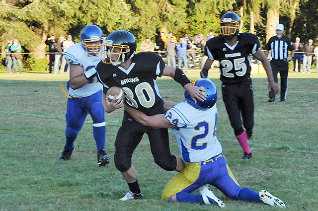 Lonnie Archibald/for Peninsula Daily News Clallam Bay’s Clayton Willis fights for yardage during a 2015 game against Crescent. The Bruins are low on numbers and scrambling to salvage a season this fall.