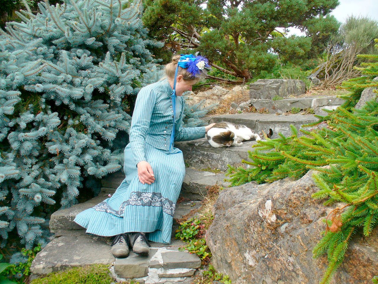 Sarah Chrisman pets the resident cat at Abkhazi Garden the day after being asked to leave Butchart Gardens. (Gabriel Chrisman)