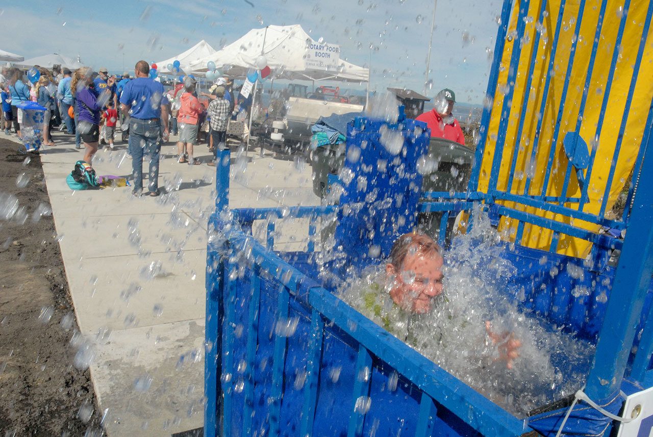 Former Clallam County Commissioner Jim McEntire falls into the water at a dunking booth set up on the new West End Park on the Port Angeles waterfront during the 2015 Jammin’ in the Park. (Keith Thorpe/Peninsula Daily News)