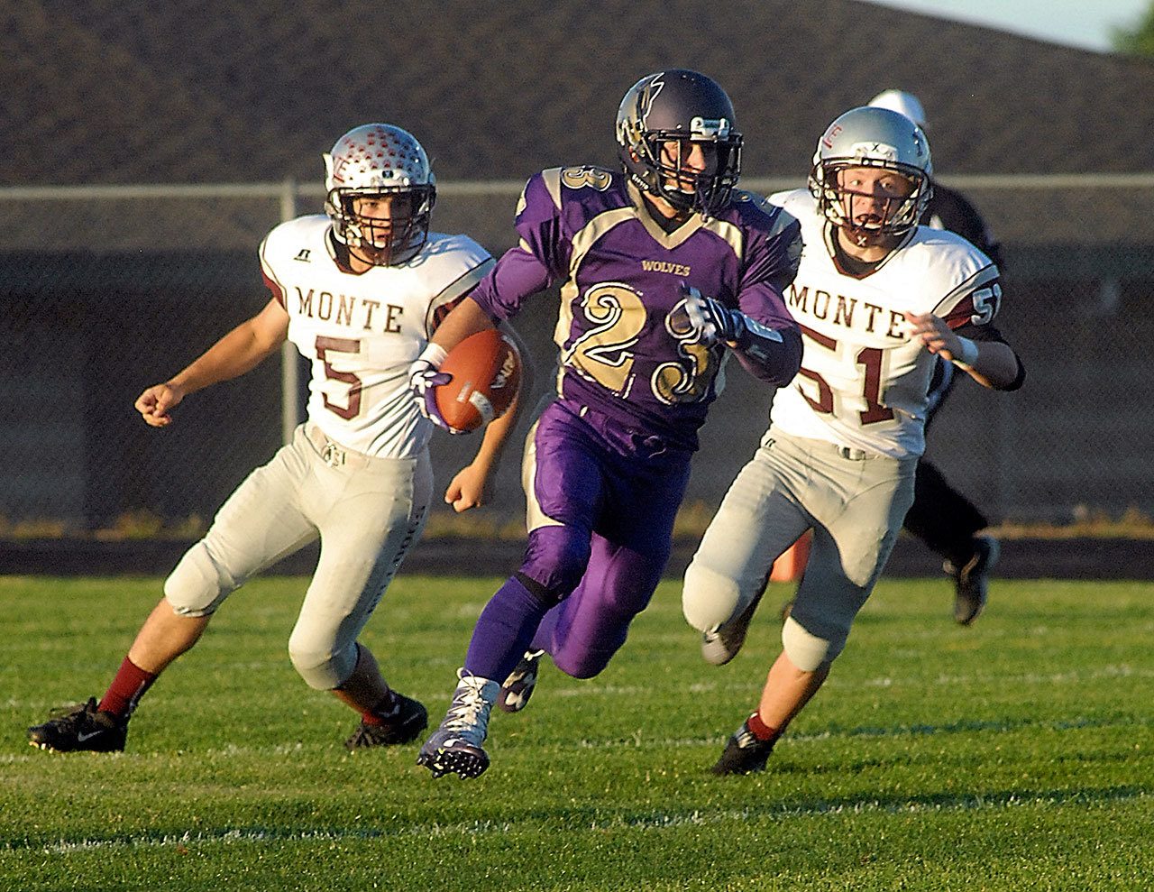 Keith Thorpe/Peninsula Daily News                                 Sequim’s Gavin Velarde, center, runs past Montesano’s Teegan Zillyett, left, and Ben Sowers for a 92-yard touchdown on the opening kickoff.