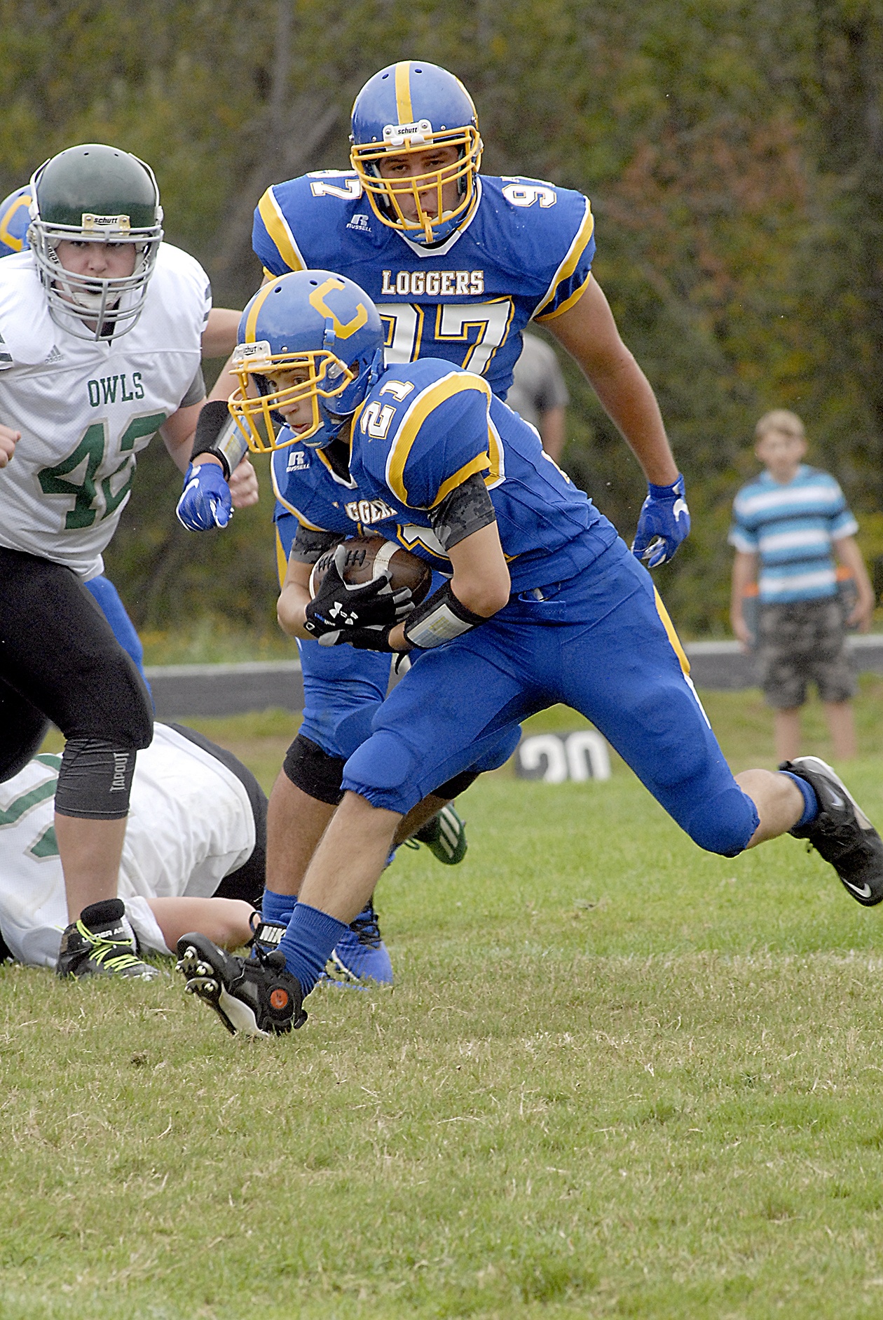 Keith Thorpe/Peninsula Daily News                                 Crescent’s Kyle Buchanan front, looks for running room as Mary M. Knight’s Reese Tottle, left, and Crescent’s McCabe Story look on during the Loggers’ 52-14 win.