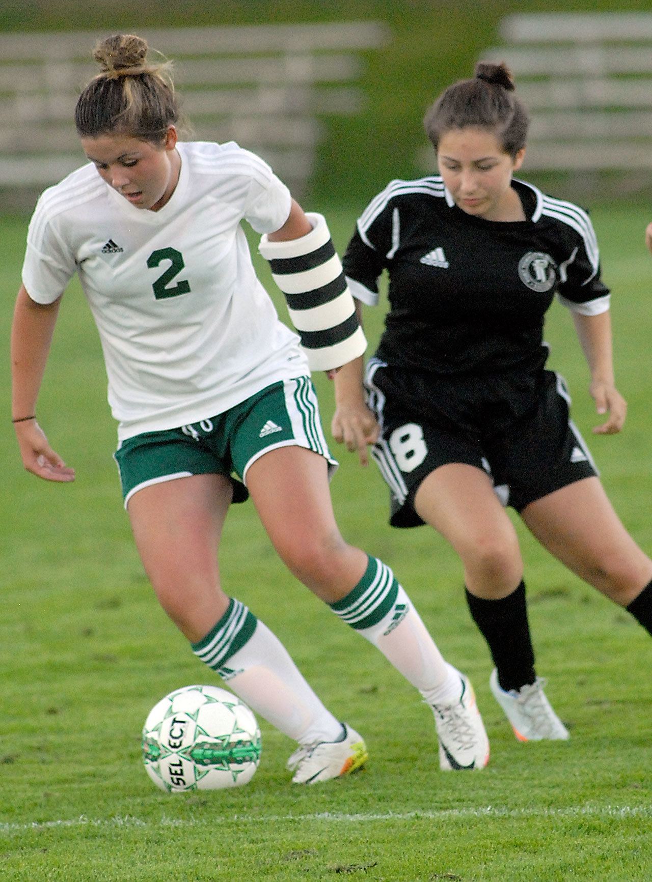 Keith Thorpe/Peninsula Daily News                                Nicole Heaton of Port Angeles, left, dribbles past Port Townsend’s Samantha Heron in first-half action on Tuesday at Port Angeles Civic Field.