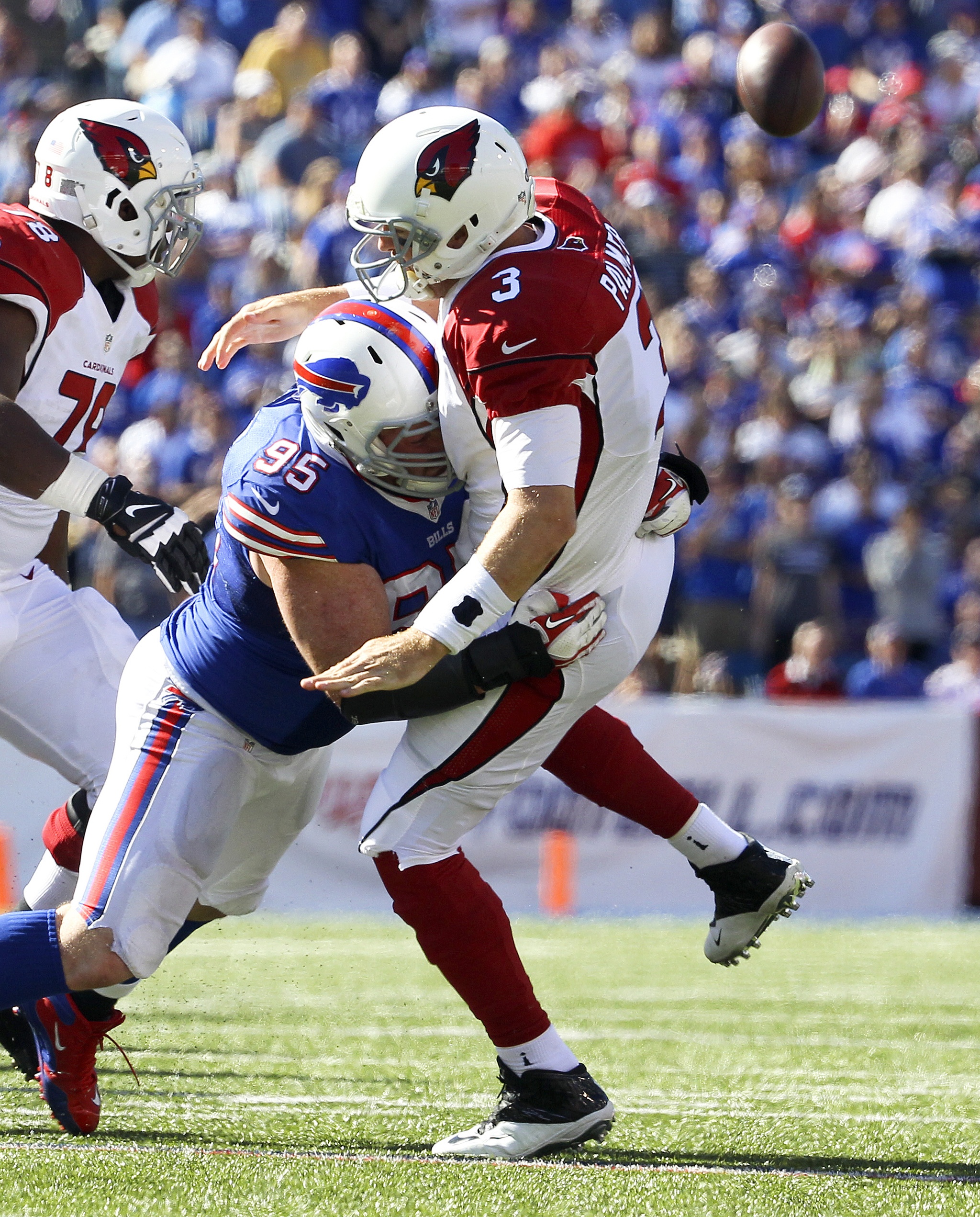 The Associated Press                                Arizona quarterback Carson Palmer (3) is hit by Buffalo’s Kyle Williams during the Bills’ 33-18 victory Sunday.