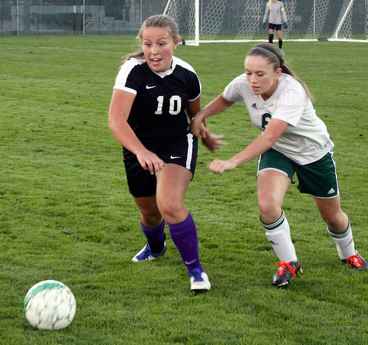 David Logan/Peninsula Daily News                                Sequim’s Chloe Sparks, left, and Port Angeles’ Emily Boyd jostle for the ball during their rivalry match at Civic Field in Port Angeles. Sequim won 3-1 in a penalty kick shootout.