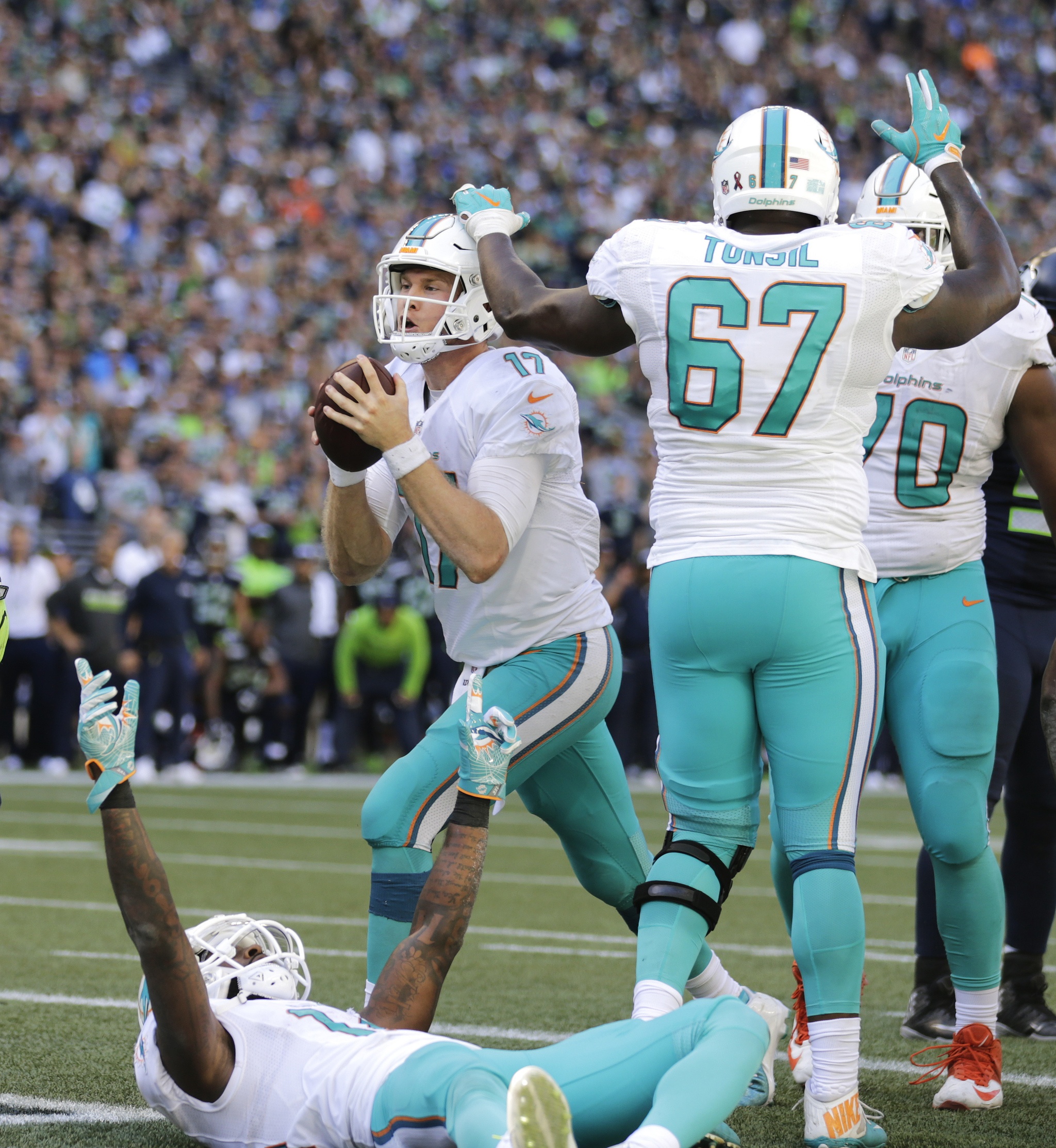 Miami Dolphins quarterback Ryan Tannehill, upper left, scores a touchdown against the Seattle Seahawks in the second half of an NFL football game, Sunday, Sept. 11, 2016, in Seattle. (AP Photo/Stephen Brashear)