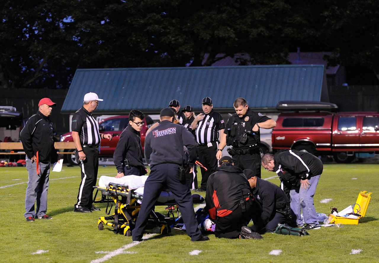 Bill Noard is cared for by emergency responders Saturday. (Michael Dashiell/Olympic Peninsula News Group)