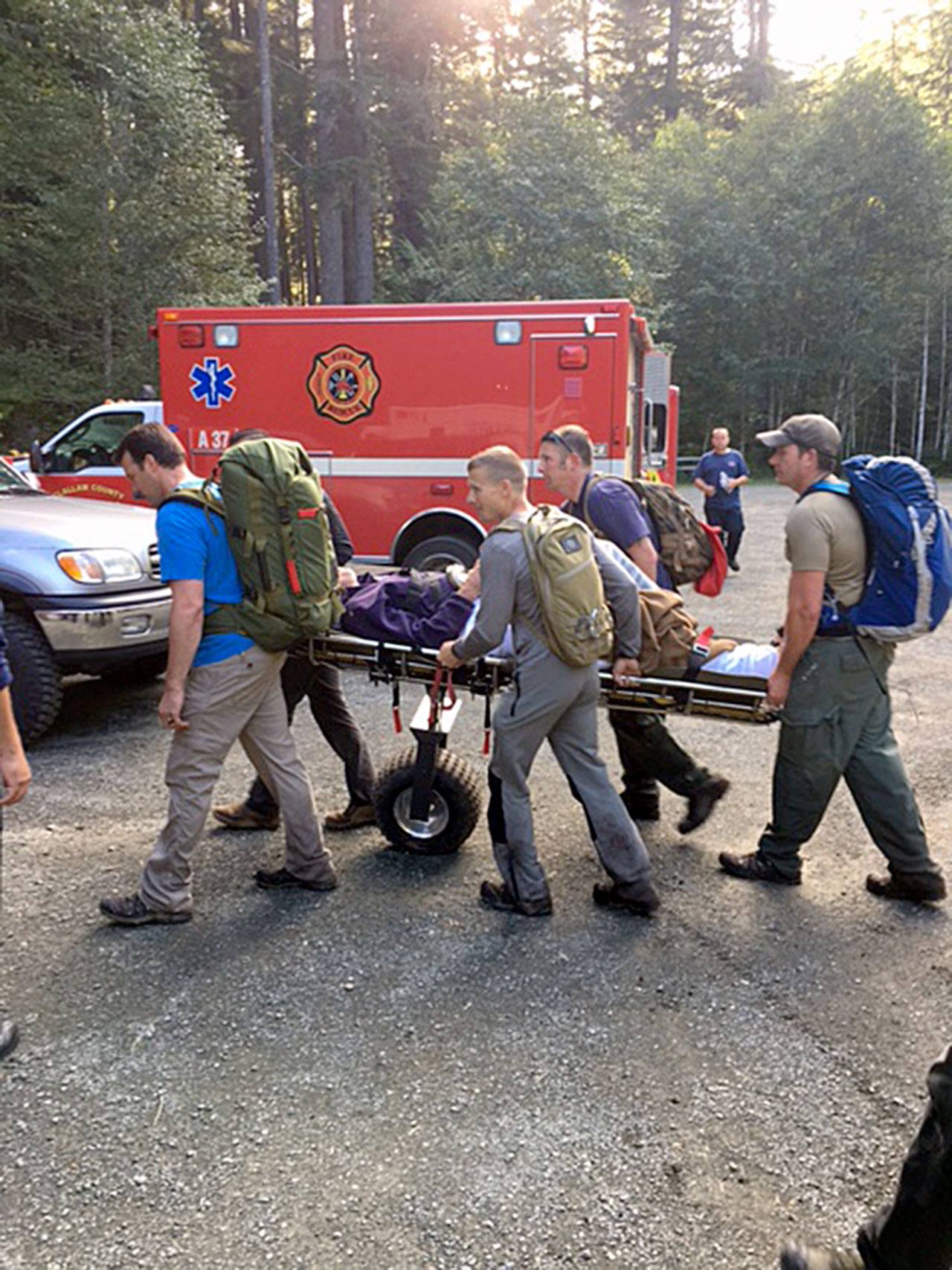 Members of the Clallam County Search and Rescue team, Clallam County Fire District No. 3 and U.S.Border Patrol work together to bring an injured hiker off a trail. (Sgt. Lyman Moores/Clallam County Sheriff’s Office)