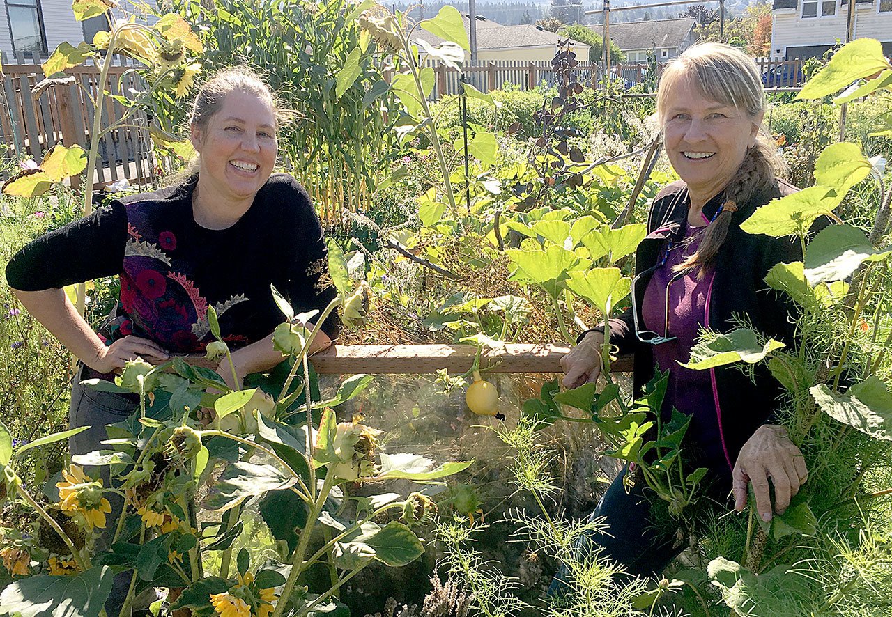 Meggan Uecker, Clallam County Solid Waste coordinator, left, and Clallam County Master Gardener Rita Cirulis are shown in front of a Hugelkultur mound at the Fifth Street Community Garden in Port Angeles. (Amanda Rosenberg/Clallam County Master Gardeners)