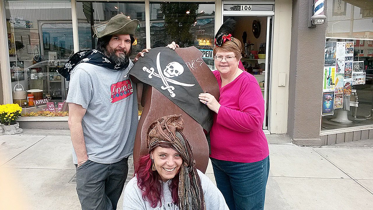 Downtown merchants Beau Damon Richards of Brocante, Elizabeth Morgan (center) of What’s In Store and Barbara Frederick ofStage Right Vintage Outfitters are adding special coupons and in-store surprises as part of the Port Angeles Downtown Association’s inaugural event “Downtown Pirate Daze,” to introduce PC students to the goods and services that are available downtown.