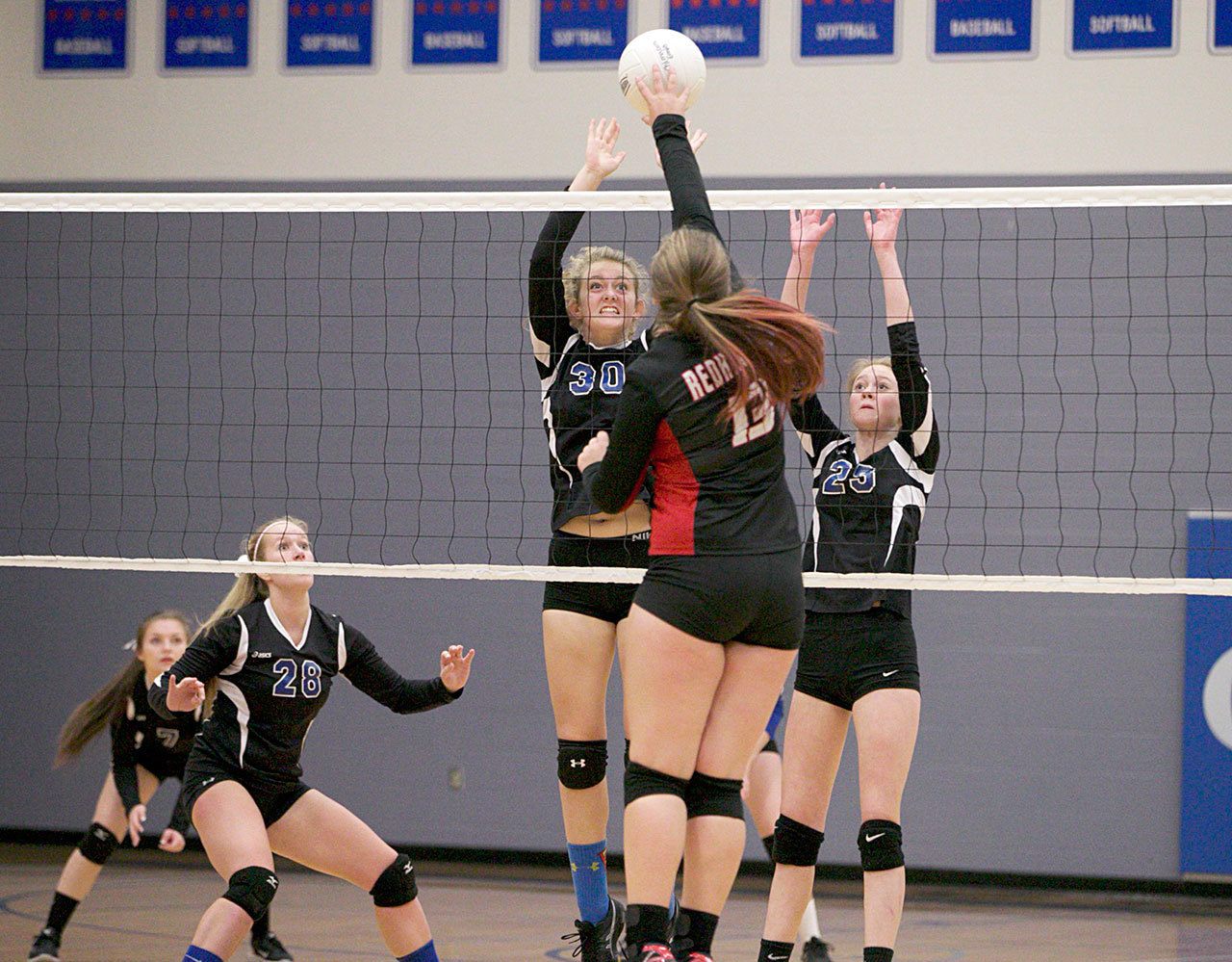 Steve Mullensky/for Peninsula Daily News                                Chimacum’s Chloe Patterson, 30, and Kyla Gates, 25, get set to block a shot by Port Townsend’s Torriana Minnahan, 13, during action in a game on Tuesday in Chimacum.