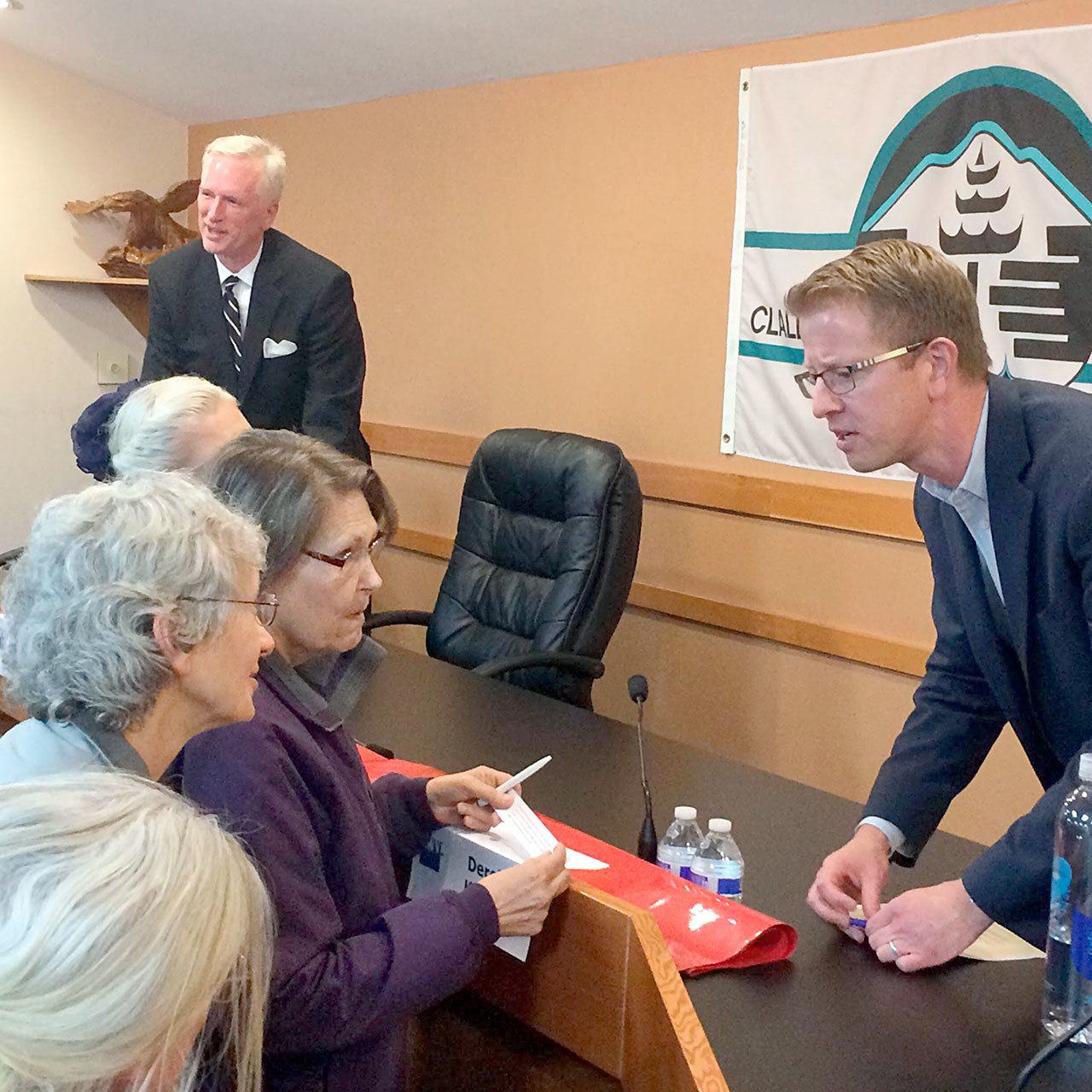 Derek Kilmer, far right, incumbent 6th District congressman, and Todd Bloom, far left, his Nov. 8 general election opponent, chat with attendees of an election forum Wednesday night at the Clallam County courthouse. (Paul Gottlieb/Peninsula Daily News)