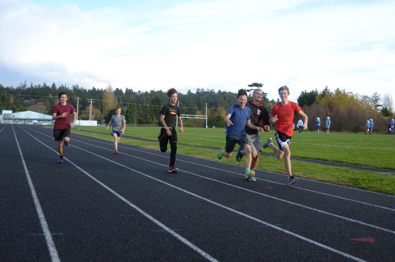 Students from the Port Townsend High School cross-country team play around during practice at the new track at Blue Heron Middle School. The new track, paid for with a capital levy, is used by Port Townsend athletes of all ages. (Cydney McFarland/Peninsula Daily News)