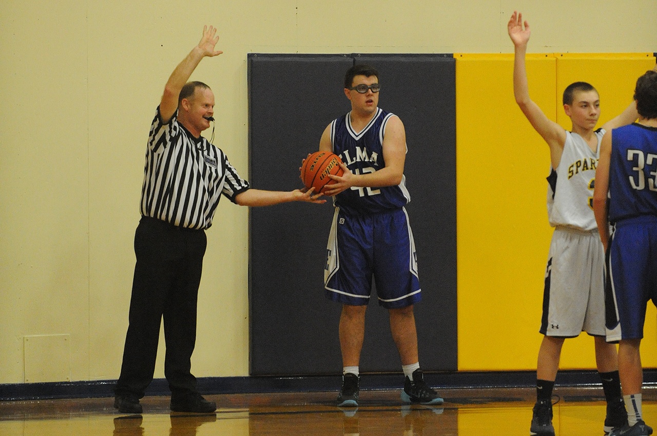 Lonnie Archibald/for Peninsula Daily News North Olympic Basketball Officials Association member Brad Archibald hands the ball over for an inbounds pass during an Elma-Forks basketball game. The association is looking for more officials to join its ranks.