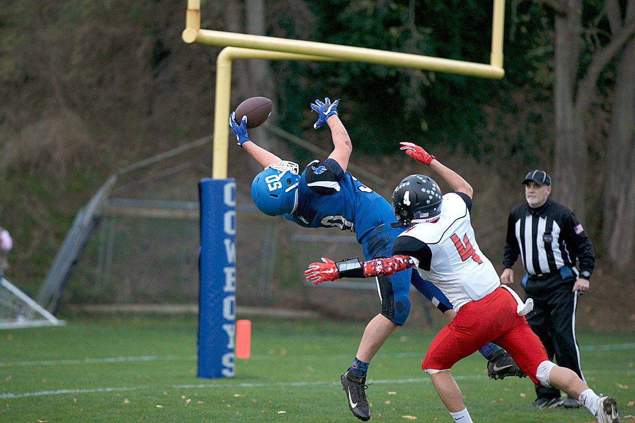 Steve Mullensky/for Peninsula Daily News Chimacum’s Bruce Seton, 50, nearly hauled in this pass for a touchdown but the ball slipped out of his hands while defended by Coupeville’s Hunter Smith.