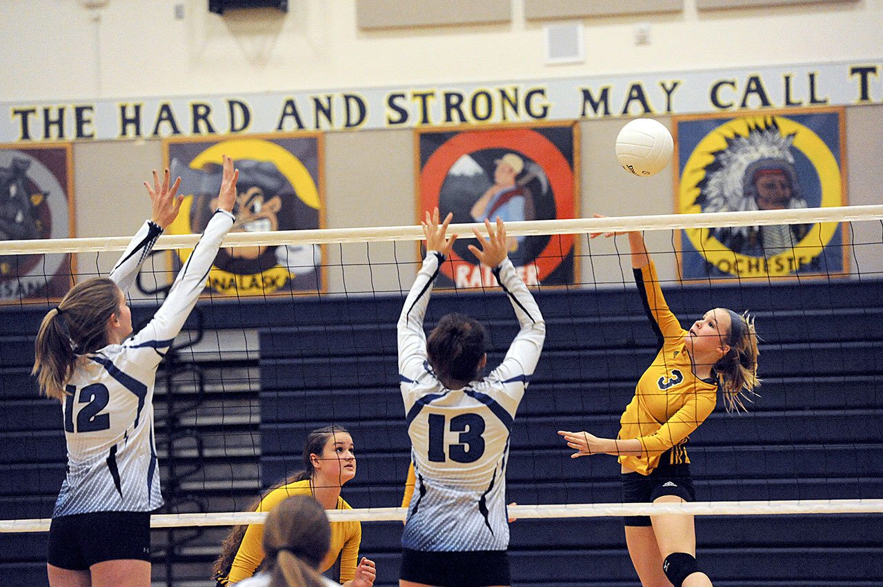 Lonnie Archibald/for Peninsula Daily News                                Forks freshman Jayden Olson hits against Elma’s Jalyn Sackrider (12) and Kali Rambo (13) during the Spartans’ three-set sweep of the Eagles.