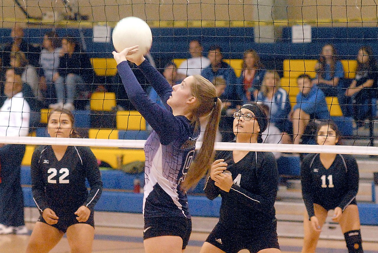 Keith Thorpe/Peninsula Daily News Quilcene’s Allison Jones, front, sets the ball as Neah Bay players, from left, Starlena Haltunnen, Alicia Loomis and Elizabeth Jimmicum prepare to defend during the first game of Saturday’s tri-district match at Crescent High School in Joyce.