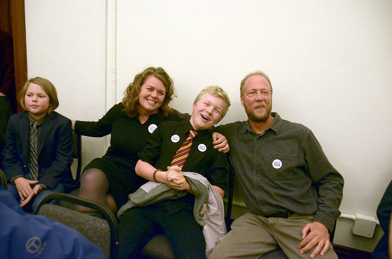 Kate Dean celebrates with Rennie and Fennegan O’Donnell and Bob Simmons after learning of her lead in the county commissioner race. (Cydney McFarland/Peninsula Daily News)