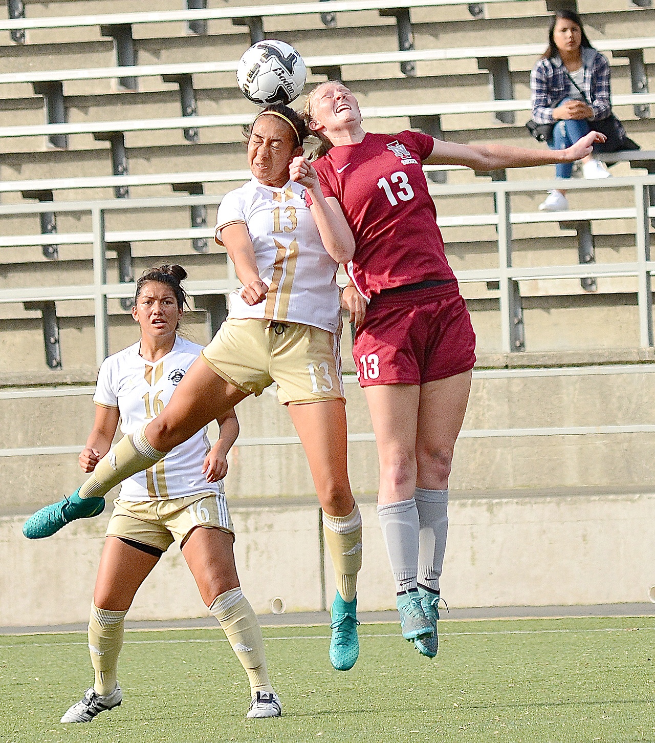 Jay Cline/for Peninsula Daily News Peninsula’s Kameryn Jury-Hale (13) and North Idaho’s Megan Lowery (13) vie for the ball as the Pirates’ Isabel Vega looks on during Peninsula’s 3-1 NWAC Soccer Semifinal at Starfire Stadium in Tukwila.