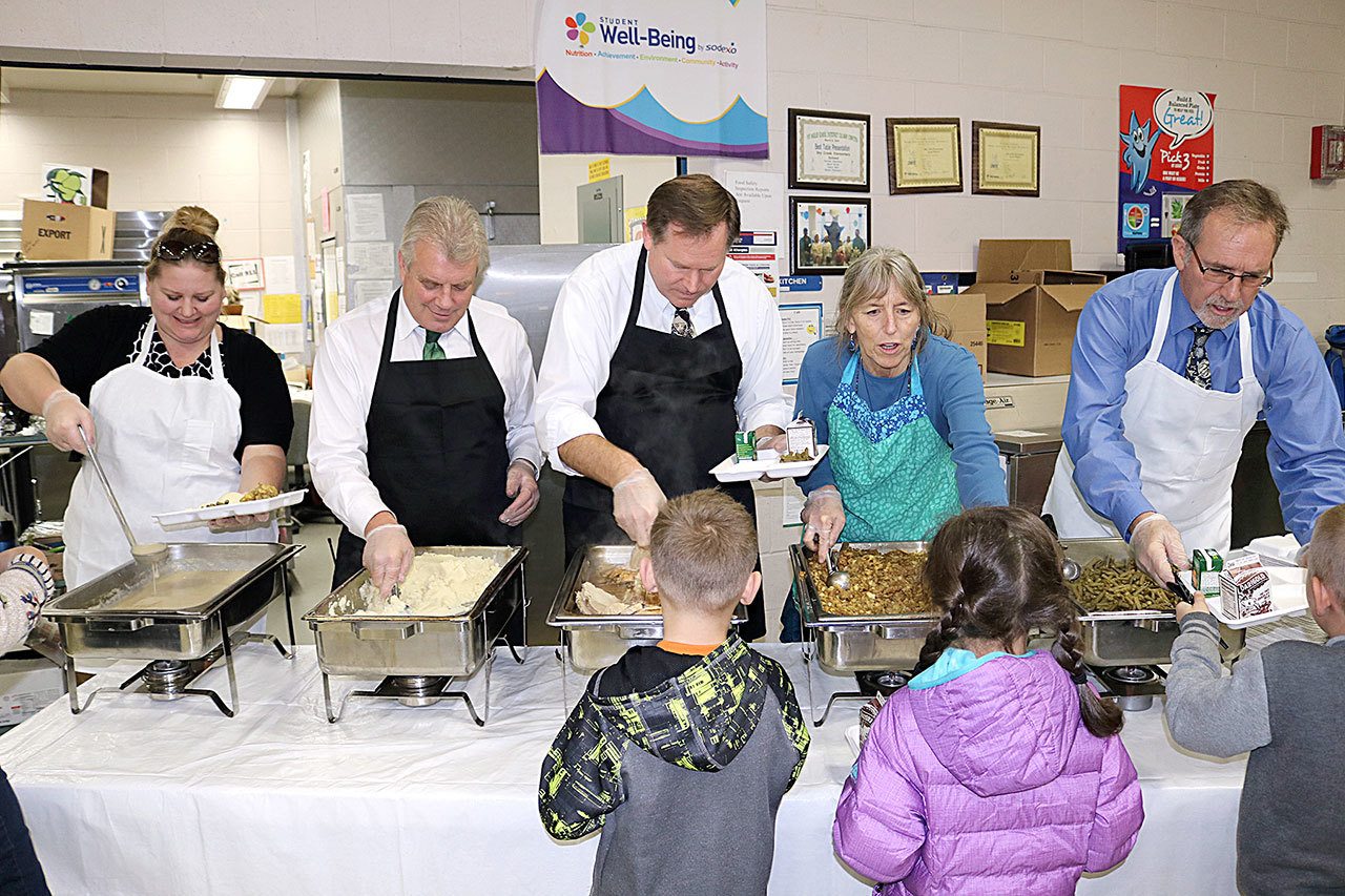 Port Angeles School District staff serve a meal of turkey, stuffing, green beans and mashed potatoes to Dry Creek Elementary students. Servers, from left, are Special Services Director Brianne Barrett, Dry Creek Principal Jay Sparks, Human Resources Director Scott Harker, counselor Laura Lilly and District Superintendent Marc Jackson. (Port Angeles School District)