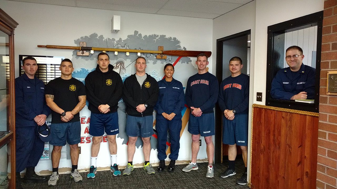 The Thanksgiving weekend staff at U.S. Coast Guard Station Quillayute River, from left, were Russell Smith, John Montenegro, Michael Laurenti, Turner Setlich, Kaya Cornejo-D’Oyen, Matthew Pullen, Irenio Riggle, and in the window Daniel Hookaday. (Zorina Barker/for Peninsula Daily News)