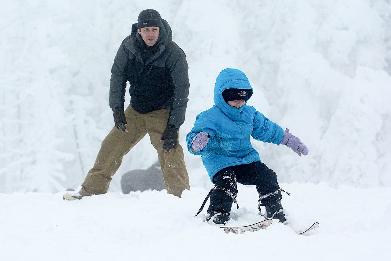 Colby Mackley of Port Angeles watches on as his 4-year-old daughter, Rio, skis at Hurricane Ridge on Sunday. (Jesse Major/Peninsula Daily News)