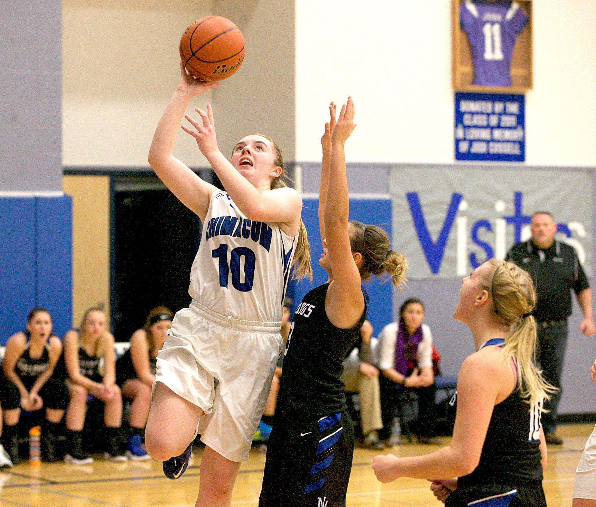 Steve Mullensky/for Peninsula Daily News Chimacum’s Maddie Dowling, 10, goes up for a score, getting past the defense of North Mason’s Hailey Simonson during the Cowboys’ 50-47 overtime win Monday in Chimacum.