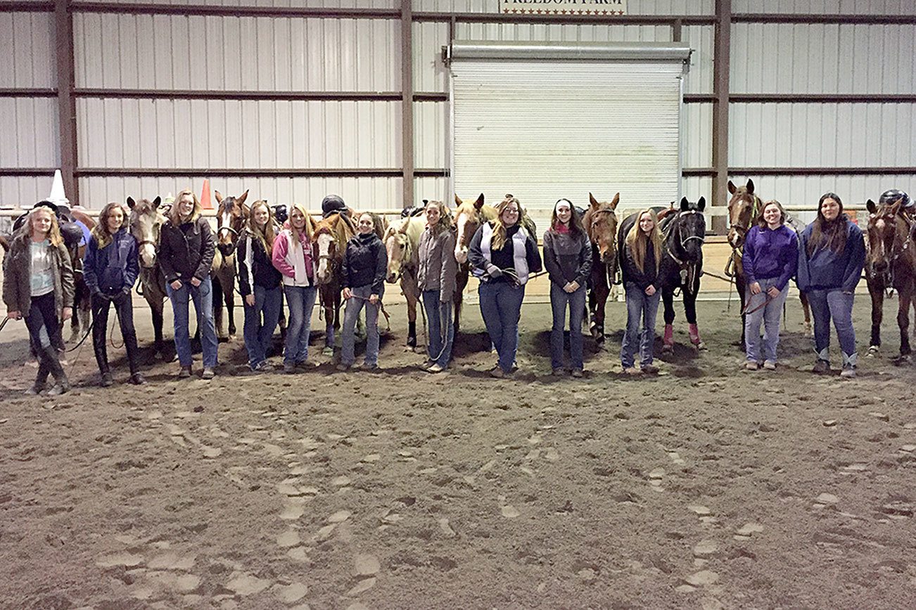 This year’s Sequim High School equestrian team members are Faith Haggie, Grace Niemeyer, Emelie Fürste, Amy Tucker, Christina Williams, Miranda Williams, Yana Hoesel, Amanda Murphy, Sydney Balkan, Abi Payseno, Madi Murphy and Lilly Thomas. The girls are show at a training session at Freedom Farm in Port Angeles. (Katie Solomon-Newton)