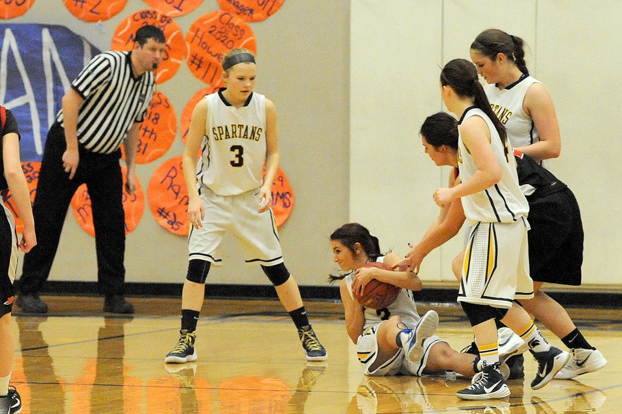 Lonnie Archibald/for Peninsula Daily News Forks’ Kaitlin Rowley keeps the ball away from the hands of Neah Bay’s Kayla Winck. Looking on for Forks are, from left, Jayden Olso, Skyler DeMatties and Rian Peters.