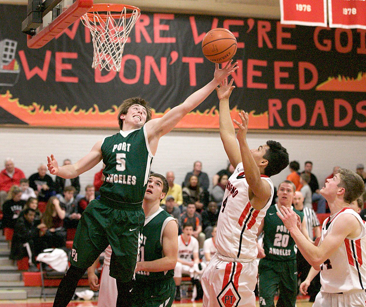 Steve Mullensky/for Peninsula Daily News Port Angeles’ Noah McGoff, left, and Port Townsend’s Jacob Boucher vie for a rebound during the Roughriders’ 62-43 win.