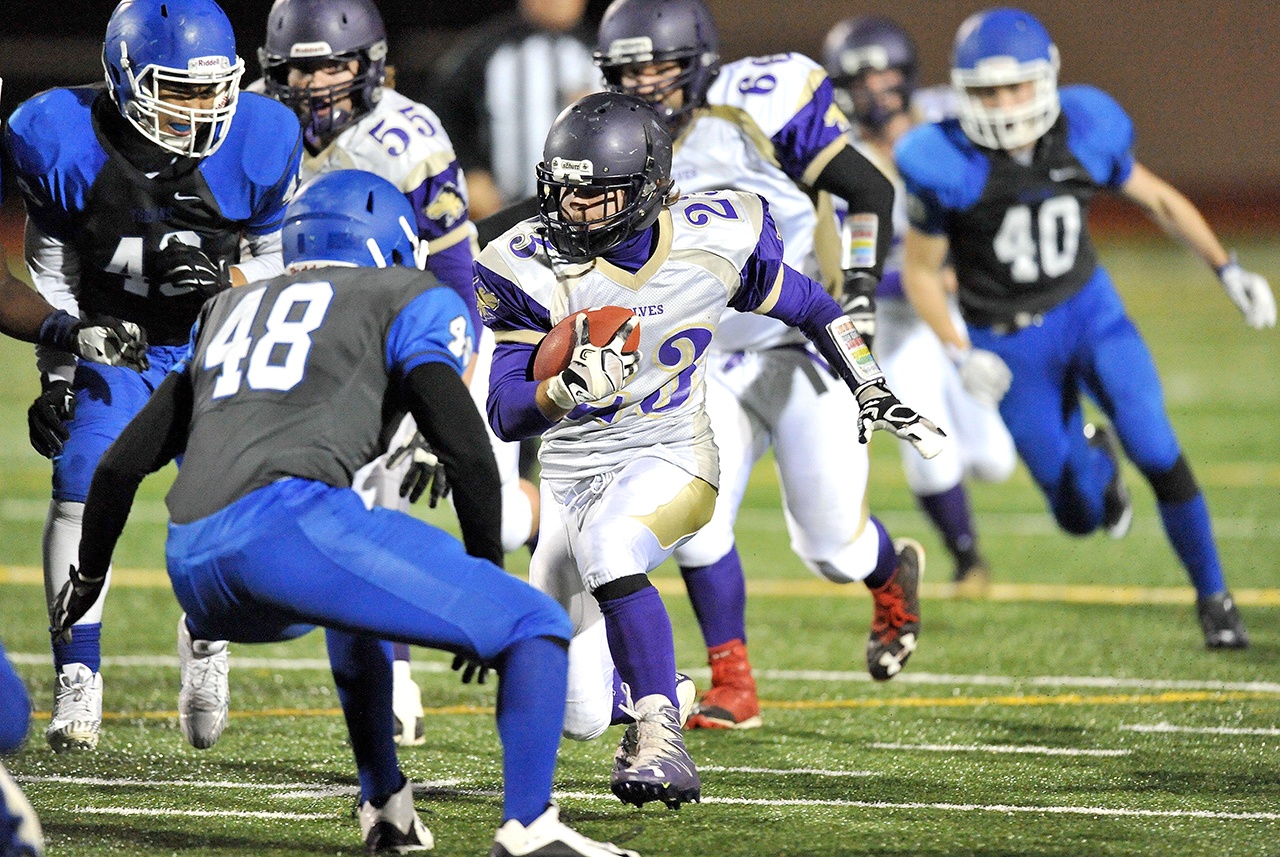 Jeff Halstead/for Peninsula Daily News Sequim’s Gavin Velarde (23) scored five touchdowns in the Wolves’ win over Olympic. Velarde has been selected the All-Peninsula Football MVP.