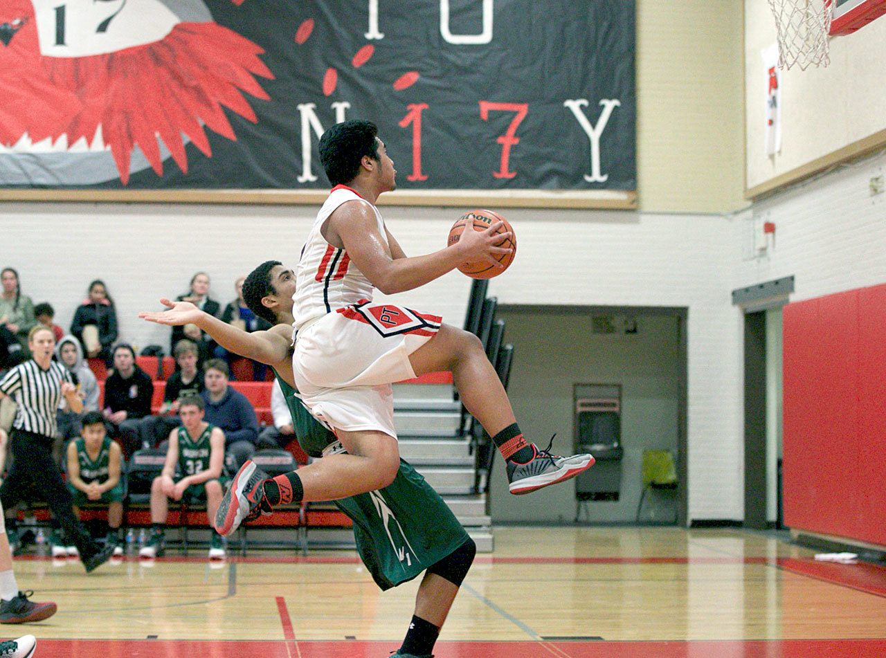 Steve Mullensky/for Peninsula Daily News                                Port Townsend’s Detrius Kelsall skies for a layup during a loss to Vashon.