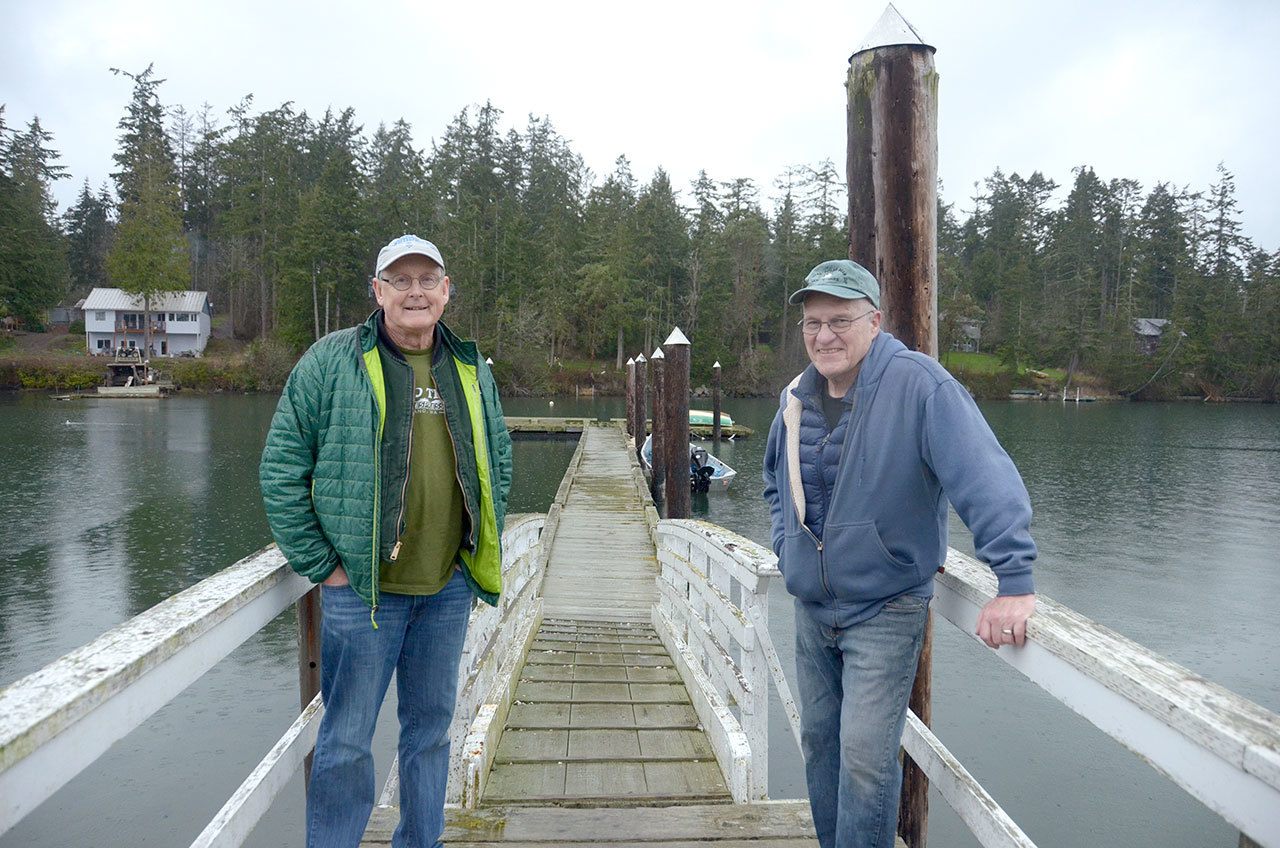 Tom Rose and Jerry Goetz stand on the dock set up for the Polar Bear Dip in Nordland where over 100 people are expected to welcome the new year. (Cydney McFarland/Peninsula Daily News)