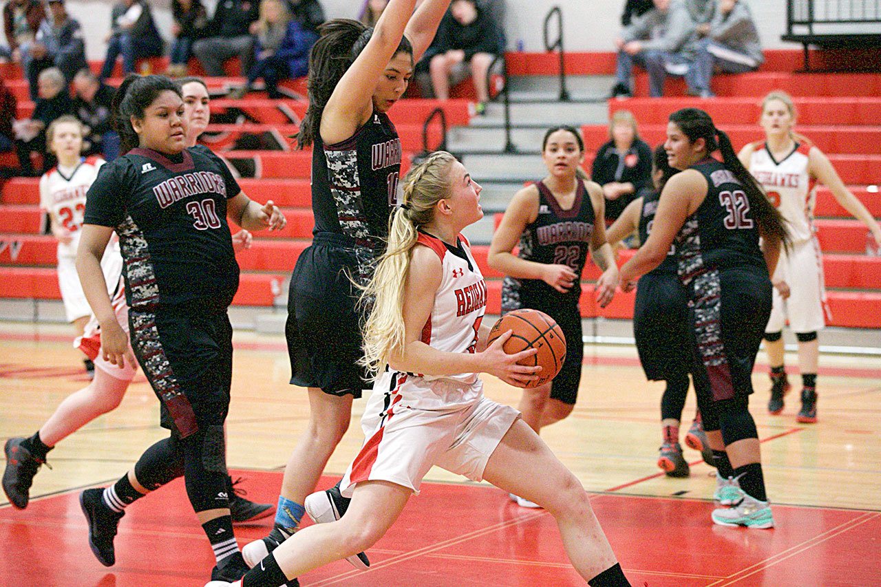 Steve Mullensky/for Peninsula Daily News Port Townsend’s Kaitlyn Meek keeps here eyes on the basket while driving for a score during the opening match-up of the 2016 Crush in the Slush against the Wahluke Warriors at Port Townsend High School on Thursday.