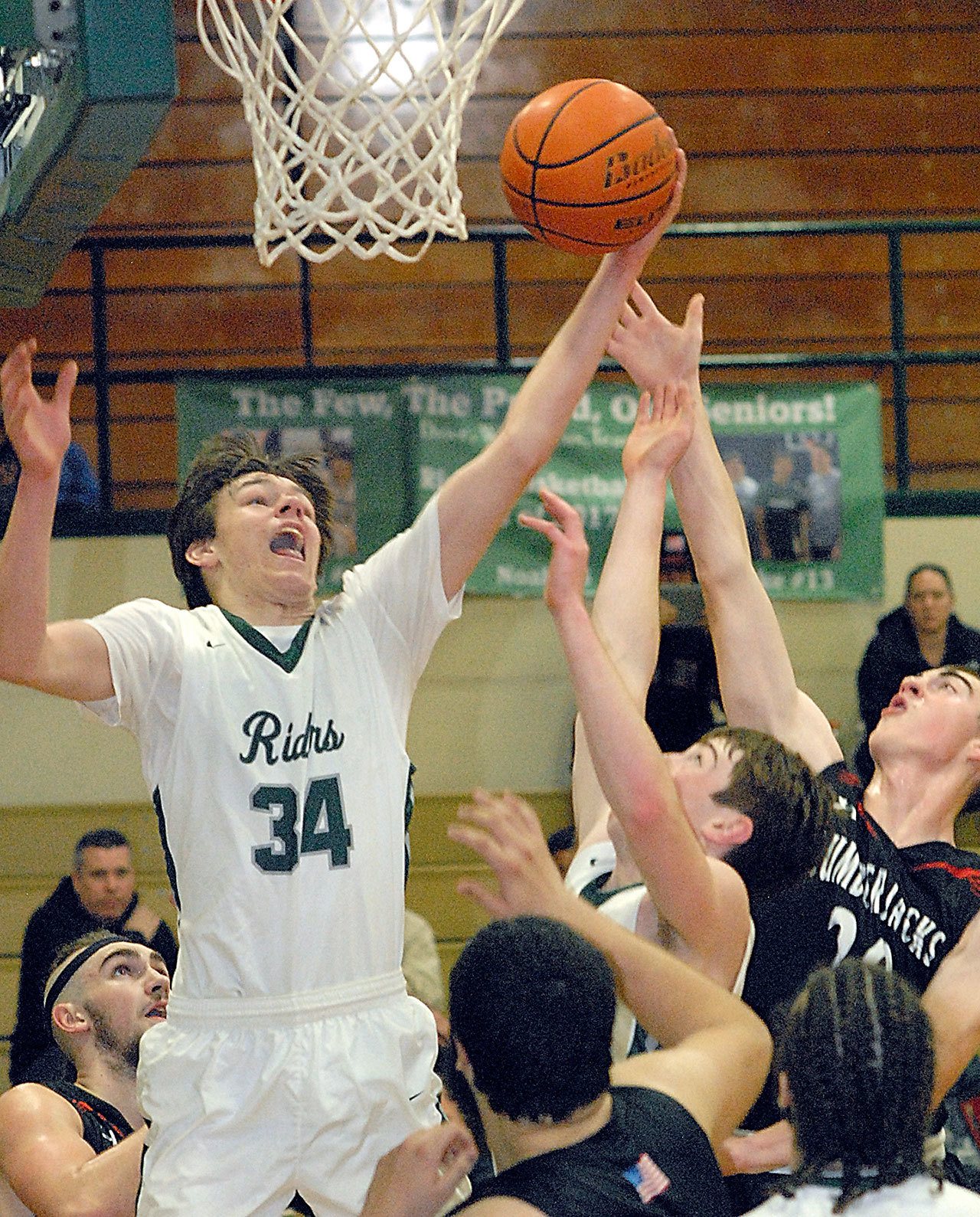 Keith Thorpe/Peninsula Daily News Port Angeles’ Liam Clark, left, and teammate Noah McGoff, center, battle for a rebound with R.A. Long’s Conner Wallace, right, during the second quarter of Friday night’s match in the Port Angeles Holiday Basketball Tournament at Port Angeles High School.