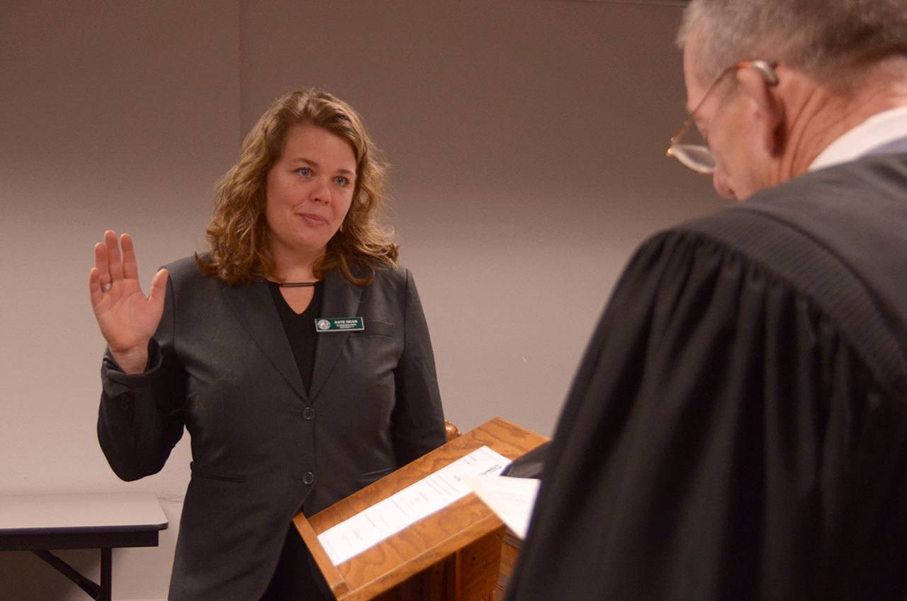 Kate Dean is sworn as as a Jefferson County commissioner for District 1 by newly sworn in Superior Court Judge Keith Harper before her first county commissioner meeting Tuesday. (Cydney McFarland/Peninsula Daily News)