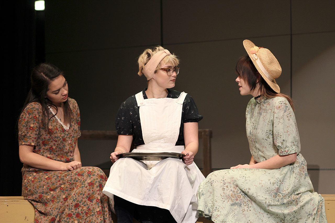 In a scene from the play “The Diviners,” Norma, played by Tiara Delatorre, left, and Madison Millet as Luella, at right, tell cafe owner Goldie, played by Hannah Black, of a curious encounter with the town’s recent visitor, Pastor C.C. Showers. (Port Angeles High School)