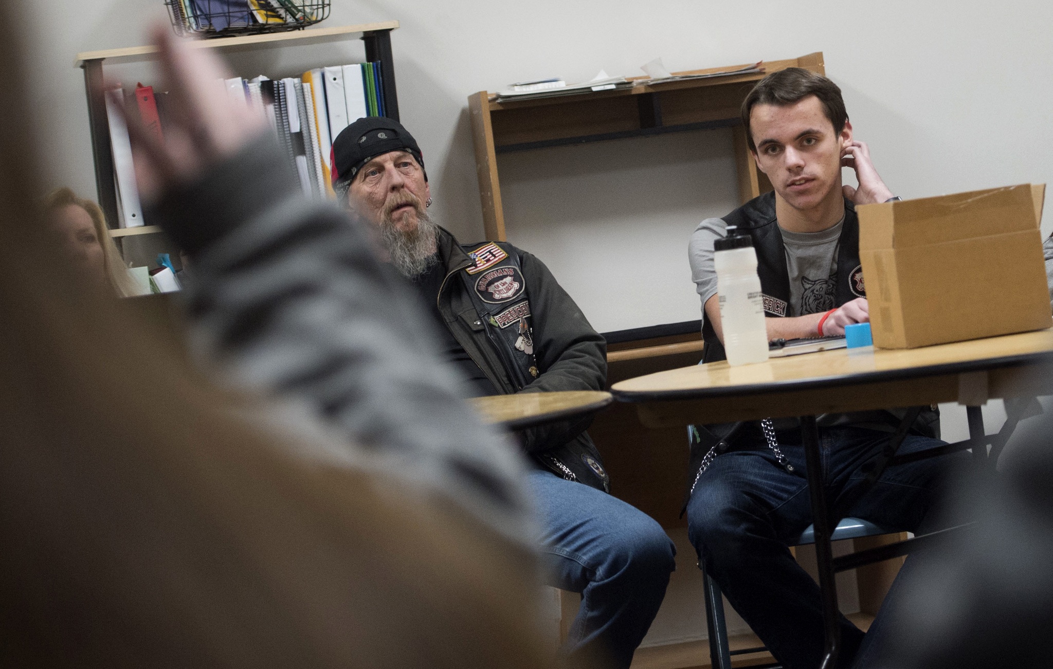 Jonathan Benecchi, right, a junior at Lewis and Clark and founder of The Little Guardians of the Children, leads a December club meeting in Spokane with Rob “Daddy Rat” Hoyt, left, of the motorcycle organization Guardians of the Children. (Tyler Tjomsland/The Spokesman-Review via AP)