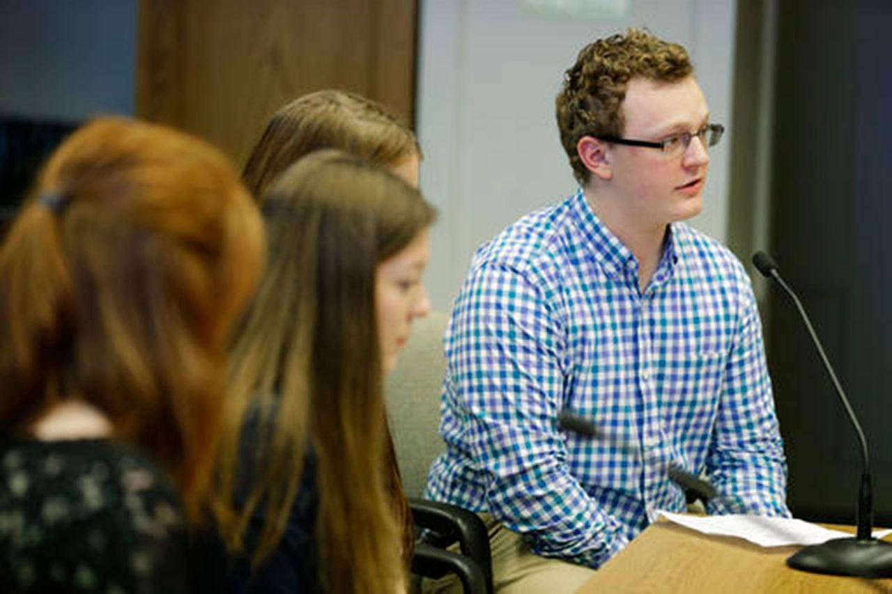 Jaxon Owens, 17, right, editor-in-chief of the Viking Vanguard student newspaper at Puyallup High School, speaks during a Senate hearing at the Capitol on Thursday in Olympia. (Ted S. Warren/The Associated Press)