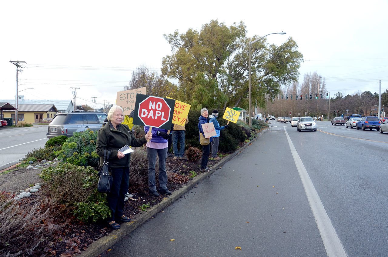 Protesters were a weekly occurrence outside Port Townsend’s Wells Fargo and Chase banks in November, as shown in this file photo, and will return Saturday to protest the banks funding the Dakota Access Pipeline. (Cydney McFarland/Peninsula Daily News)