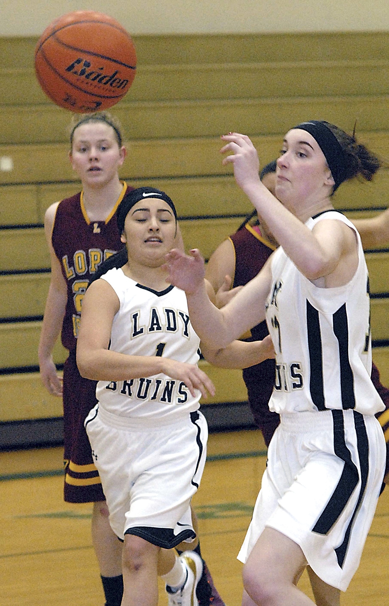 Keith Thorpe/Peninsula Daily News                                Clallam Bay’s Mariah LaChester, front left, and Molly McCoy, right, chase after a loose ball as Lopez Island’s Zoe Reinmuth looks on during the Bruins’ Class 1B Tri-District Tournament win at Port Angeles High School.