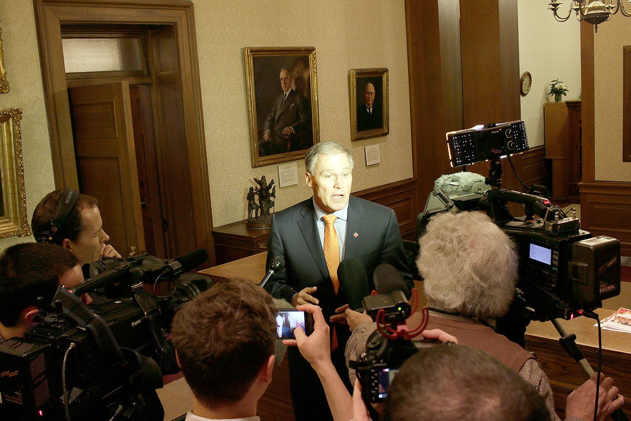 Gov. Jay Inslee talks to reporters Thursday in Olympia following a federal appeals court’s refusal to reinstate President Donald Trump’s travel ban. (Rachel La Corte/The Associated Press)