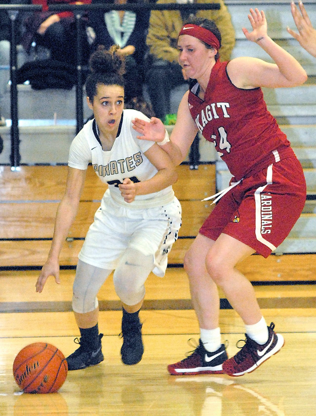 Keith Thorpe/Peninsula Daily News Peninsula’s Sephora Yayouss slides past Skagit Valley’s Emily Yost in the fourth quarter of Wednesday night’s matchup in Port Angeles.