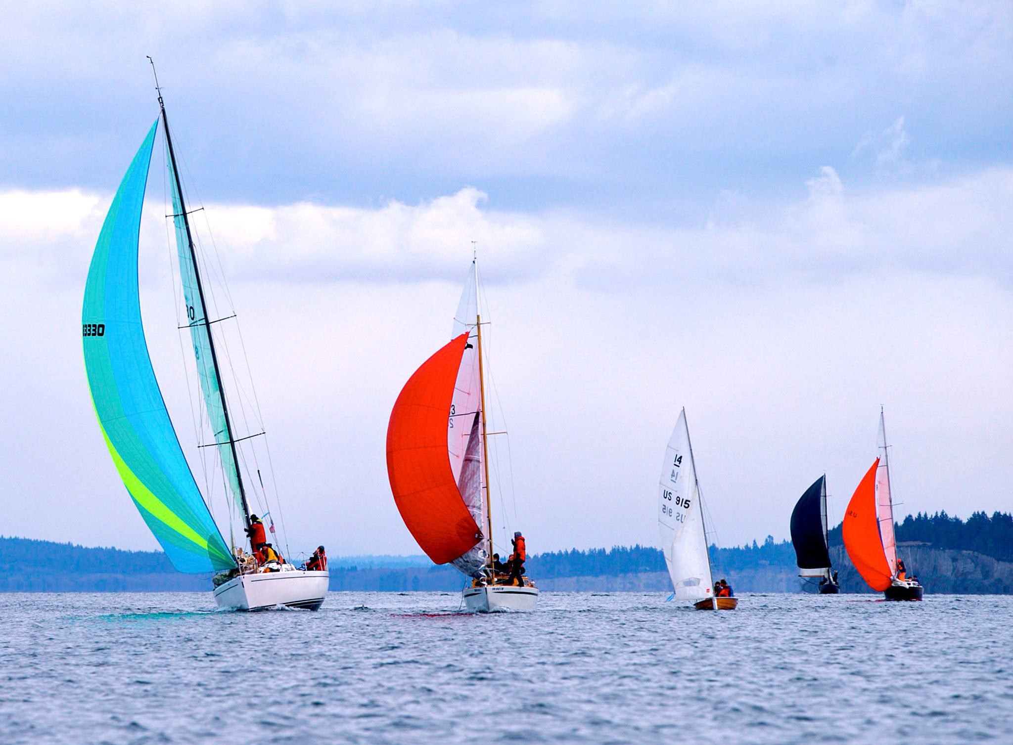 Steve Mullensky/for Peninsula Daily News                                A line of sailboats, on a downwind reach, compete in the 26th annual Shipwrights’ Regatta on Port Townsend Bay on Saturday.