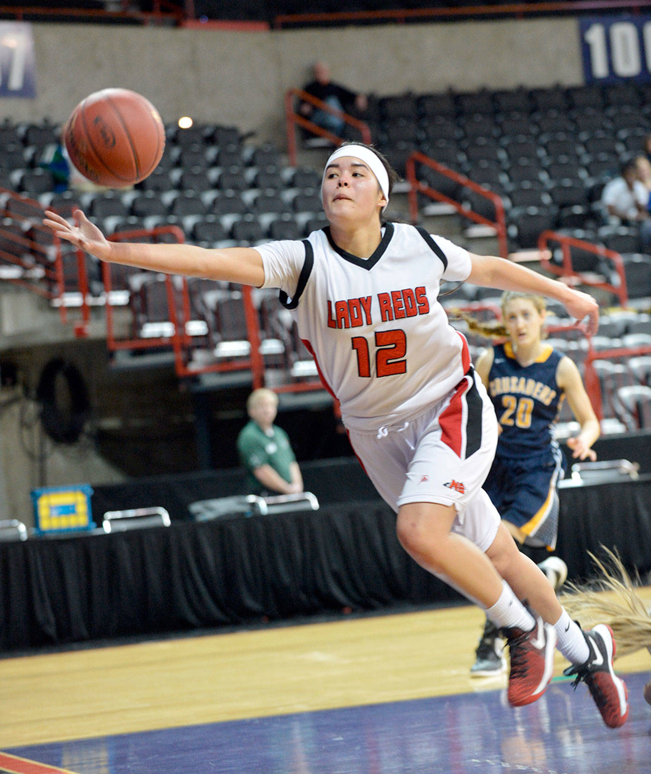 Al Camp/Omak Chronicle Neah Bay’s Vonte Aguirre reaches for a loose ball during the Red Devils’ 60-57 loss to Tacoma Baptist in the Class 1B girls basketball state tournament Friday at Spokane Arena.