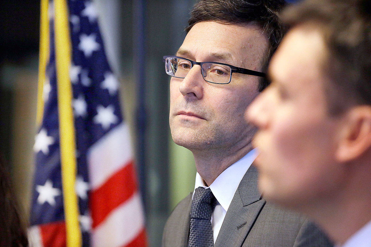 Elaine Thompson/The Associated Press                                 State Attorney General Bob Ferguson listens to a question at a news conference Thursday in Seattle.